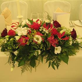 fwthumbPetite top table display of roses, gloriosa and fressia.jpg